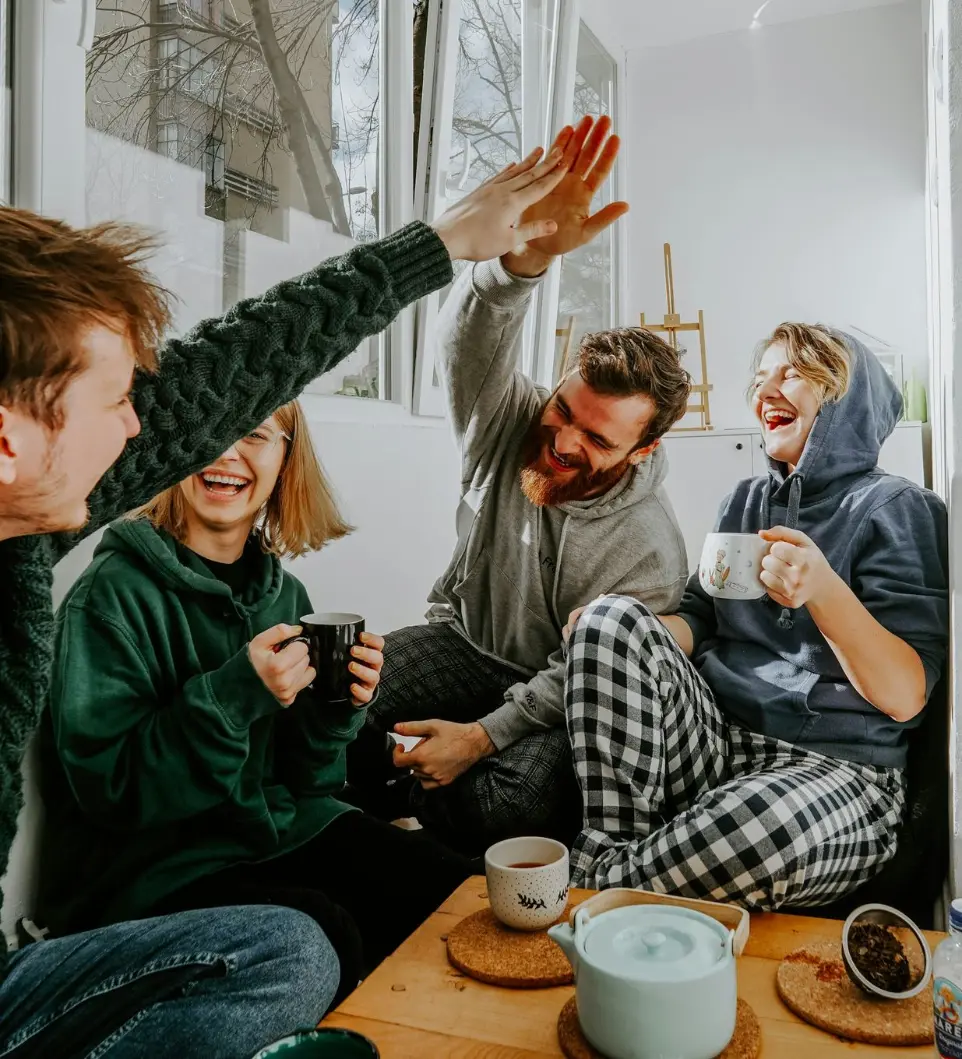 woman in black and white checkered long sleeve shirt sitting beside man in green crew neck